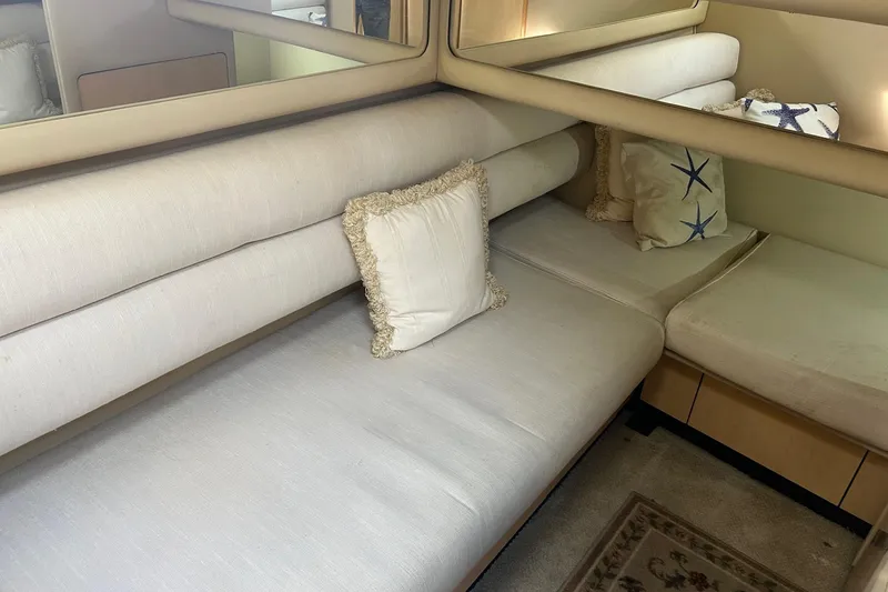 Slide: The Image of Interior of 2001 Sea Ray 480 Sedan Bridge with beige seating and decorative pillows. - 42