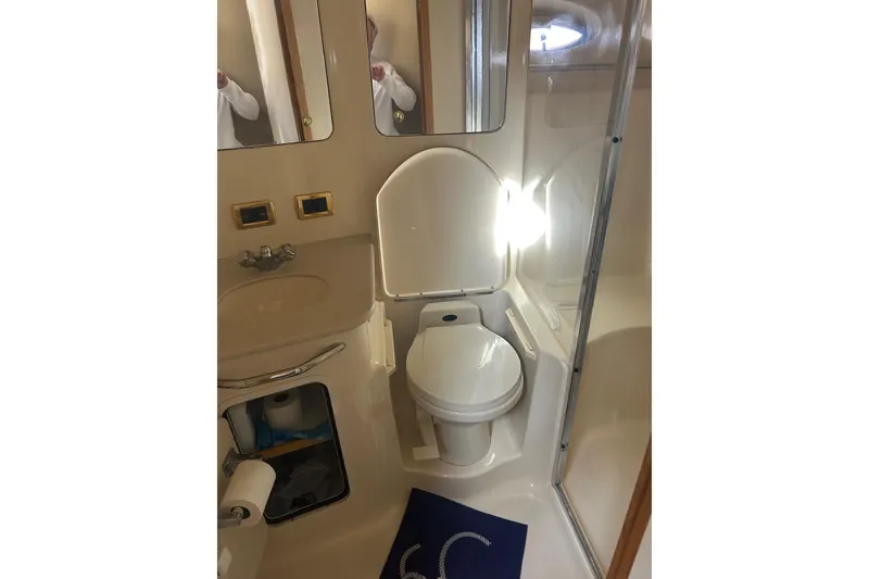 Slide: The Image of Bathroom interior of 2001 Sea Ray 480 Sedan Bridge yacht, featuring toilet and sink. - 43