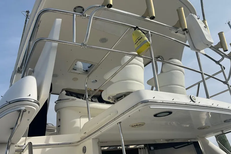 Slide: The Image of 2001 Sea Ray 480 Sedan Bridge yacht, upper deck view with seating and railings. - 5