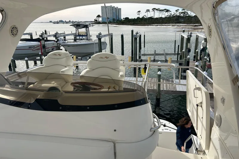 Slide: The Image of 2001 Sea Ray 480 Sedan Bridge yacht docked at marina with scenic waterfront view. - 9