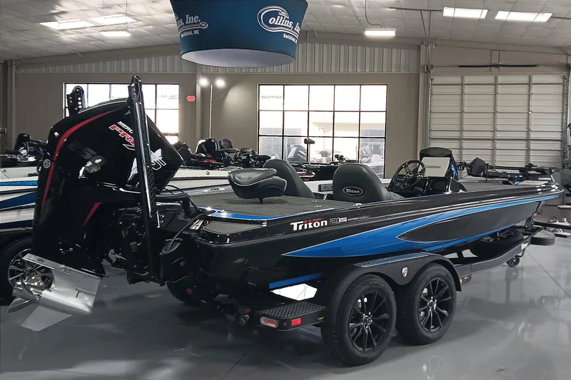 Slide: The Image of 2026 Triton 21XP Patriot boat in showroom, featuring sleek design and powerful engine. - 1