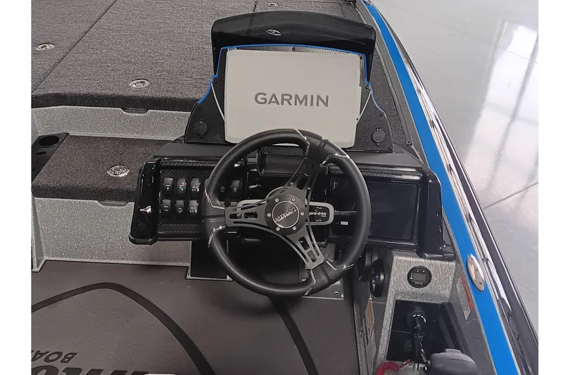 Slide: The Image of 2026 Triton 21XP Patriot boat dashboard with Garmin display and steering wheel. - 11