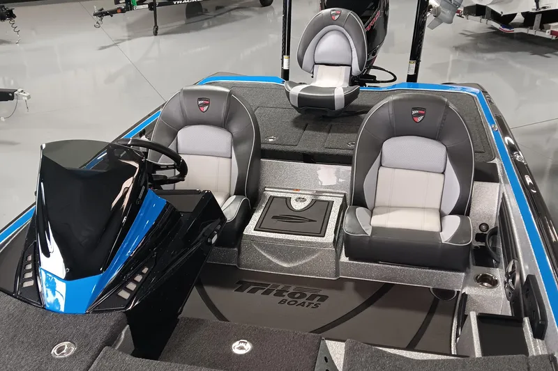Slide: The Image of 2026 Triton 21XP Patriot boat interior with sleek seating and modern dashboard design. - 12