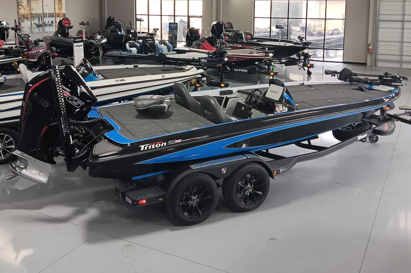 Slide: The Image of 2026 Triton 21XP Patriot bass boat in showroom, featuring sleek design and modern equipment. - 2