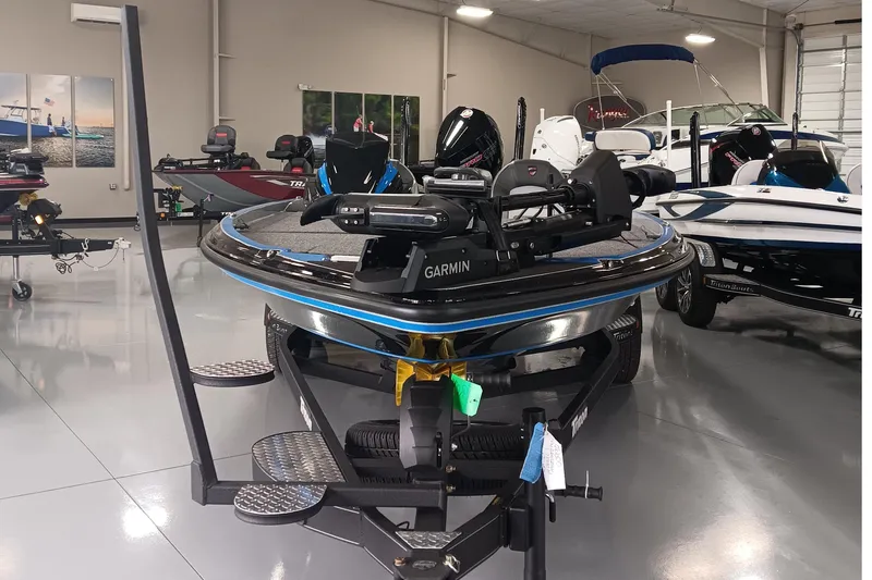 Slide: The Image of 2026 Triton 21XP Patriot boat in showroom, featuring Garmin equipment. - 3