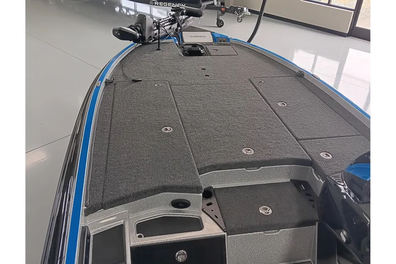 Slide: The Image of 2026 Triton 21XP Patriot boat interior with carpeted deck and Garmin equipment. - 9