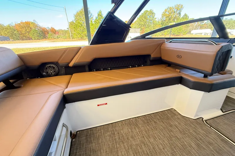 Slide: The Image of 2025 Cobalt R8 boat interior with tan leather seating and modern design. - 10