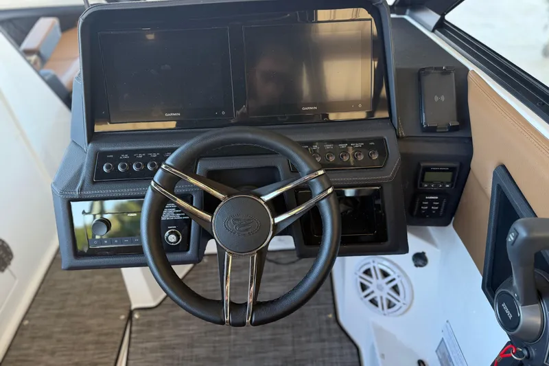 Slide: The Image of 2025 Cobalt R8 boat dashboard with steering wheel and digital displays. - 14
