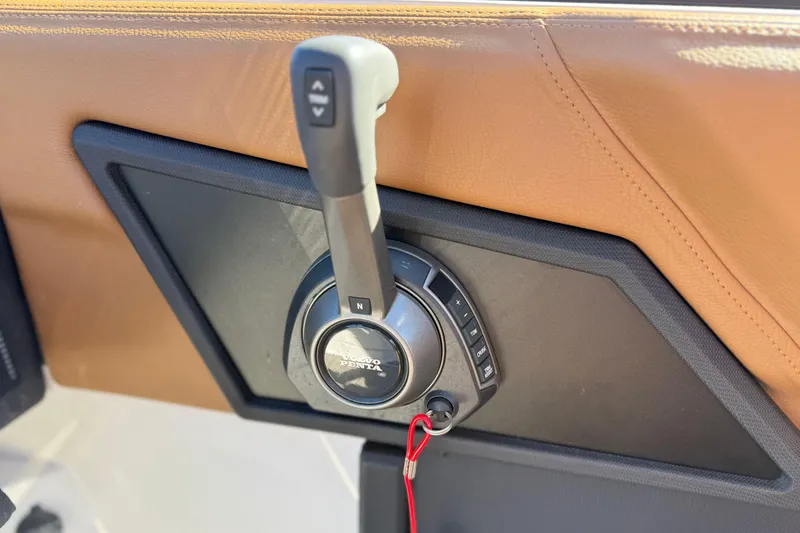 Slide: The Image of 2025 Cobalt R8 control panel with Volvo Penta throttle lever, featuring tan leather trim. - 16