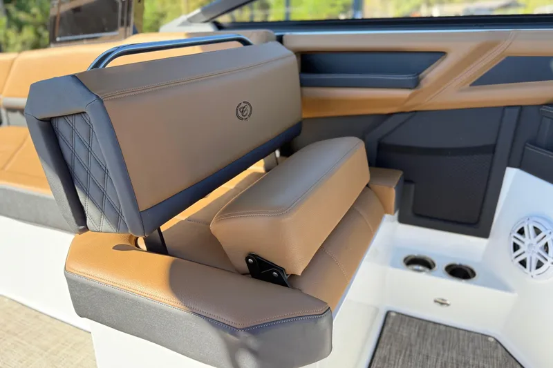 Slide: The Image of 2025 Cobalt R8 boat interior with luxurious tan and black seating, cup holders, and speaker. - 18