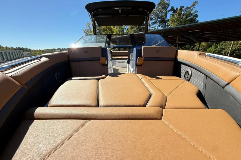 Slide: The Image of 2025 Cobalt R8 boat interior with tan leather seating and open deck view. - 21