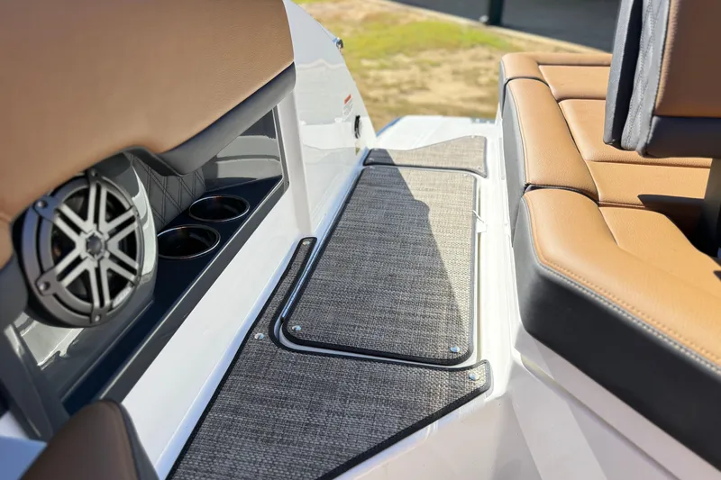 Slide: The Image of 2025 Cobalt R8 boat interior with tan seating, speaker, and cup holders. - 25