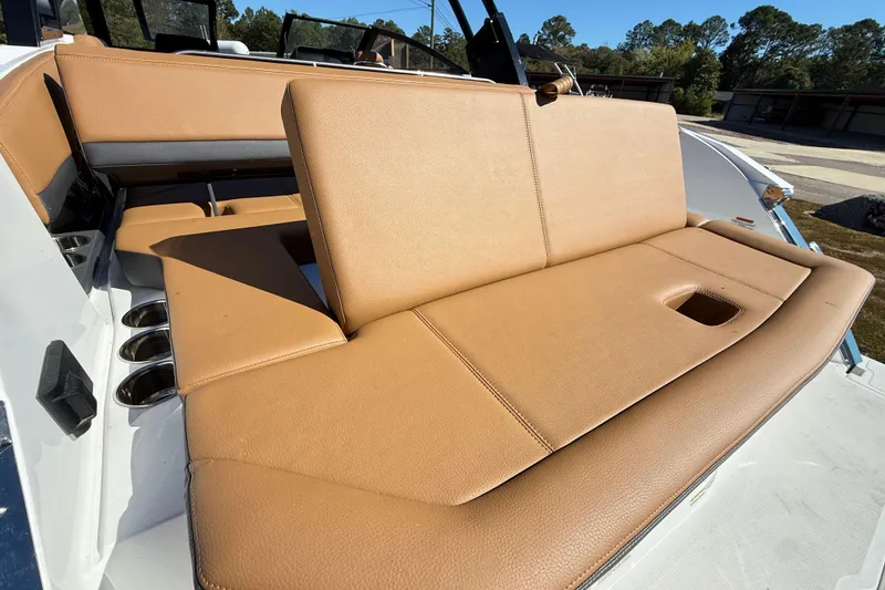 Slide: The Image of 2025 Cobalt R8 boat with tan leather seating and cup holders. - 27
