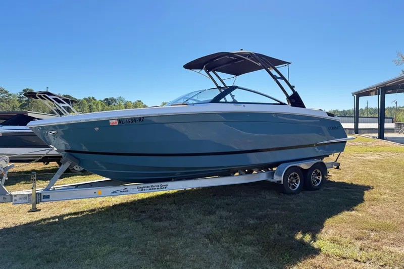 Slide: The Image of 2025 Cobalt R8 boat on trailer, parked outdoors under clear blue sky. - 4