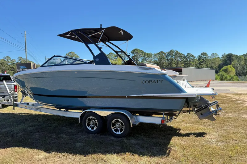 Slide: The Image of 2025 Cobalt R8 boat on trailer, parked outdoors under clear blue sky. - 5