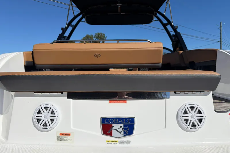 Slide: The Image of 2025 Cobalt R8 boat rear view with speakers and seating, showcasing luxury design. - 8