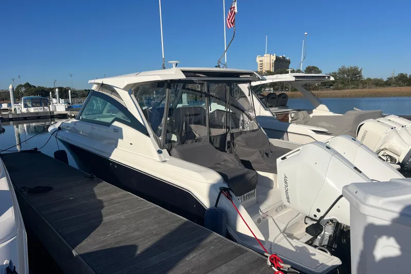 Slide: The Image of 2025 Tiara Yachts 34 LX docked, featuring sleek design and powerful Mercury engines. - 2