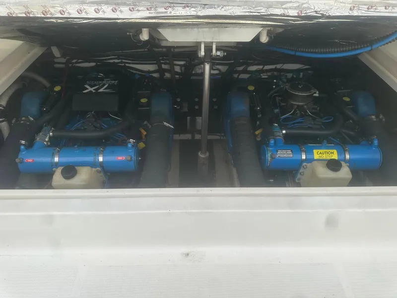 Slide: The Image of 1995 Tiara Sport 3100 engine compartment with dual blue marine engines. - 10