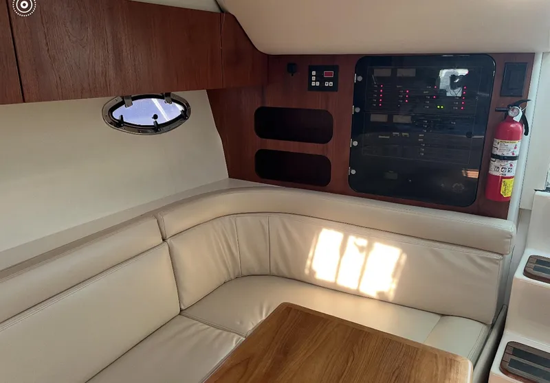 Slide: The Image of Interior of 1995 Tiara Sport 3100 yacht with leather seating and control panel. - 4