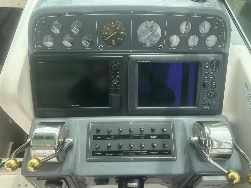 Slide: The Image of Control panel of a 1995 Tiara Sport 3100 boat with gauges and navigation screens. - 6