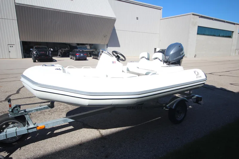 Slide: The Image of 2025 Zodiac Yachtline 360 DL NEO 40hp boat on trailer, parked outdoors. - 3