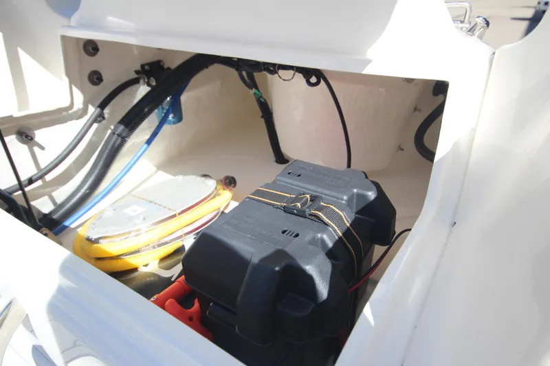 Slide: The Image of 2025 Zodiac Yachtline 360 DL NEO 40hp storage compartment with battery and cables. - 6