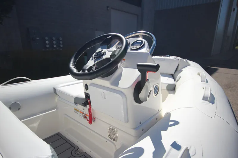 Slide: The Image of 2025 Zodiac Yachtline 360 DL NEO boat interior with steering wheel and controls. - 9