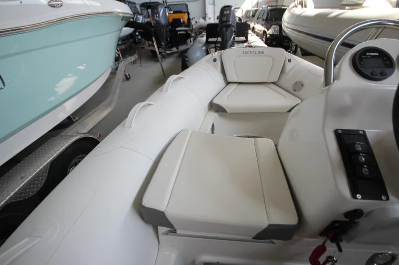 Slide: The Image of 2026 Zodiac Yachtline Deluxe 360 inflatable boat interior with seating and control panel. - 13