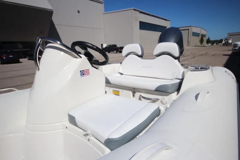 Slide: The Image of 2025 Zodiac Yachtline 360 DL NEO 40hp boat interior with seating and steering wheel. - 4