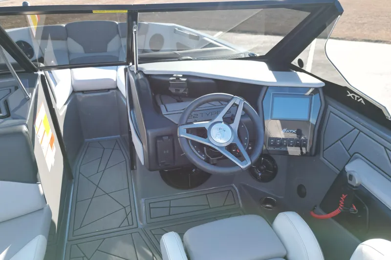 Slide: The Image of 2021 ATX Surf Boats 22 Type-S interior with steering wheel and dashboard controls. - 13