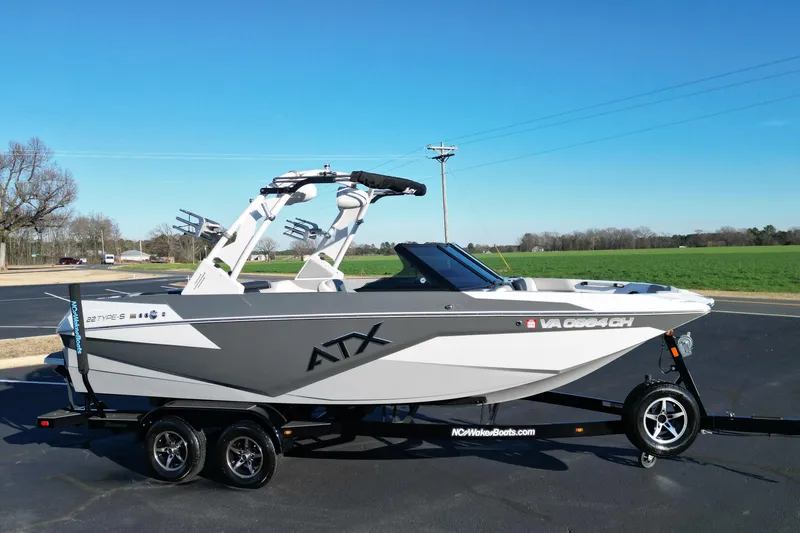 Slide: The Image of 2021 ATX Surf Boats 22 Type-S on trailer, parked outdoors under clear blue sky. - 3