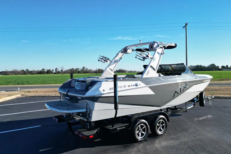 Slide: The Image of 2021 ATX Surf Boats 22 Type-S on trailer, parked outdoors under clear blue sky. - 6