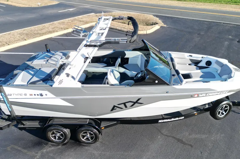 Slide: The Image of 2021 ATX Surf Boats 22 Type-S on trailer, sleek design, gray and white color scheme. - 7