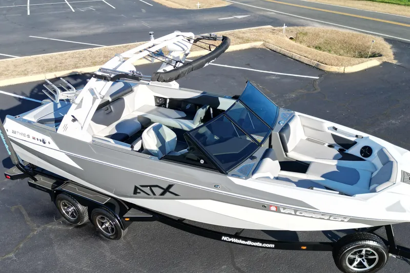 Slide: The Image of 2021 ATX Surf Boats 22 Type-S on trailer, sleek design, parked in lot. - 9