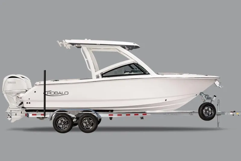 The Image of 2026 Robalo R257 Dual Console boat on trailer, side view, gray background. - 0