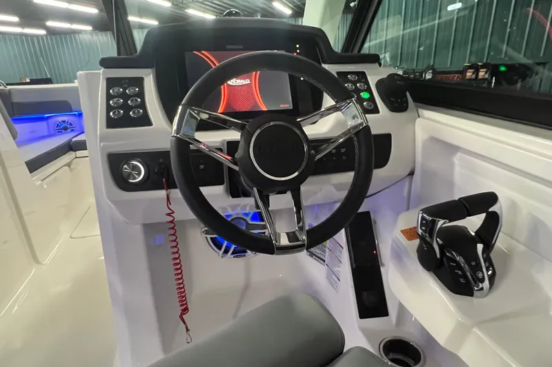 Slide: The Image of 2026 Robalo R257 Dual Console boat cockpit with modern steering and controls. - 10