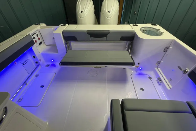Slide: The Image of 2026 Robalo R257 Dual Console boat interior with seating and blue LED lighting. - 13