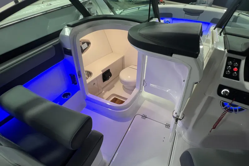 Slide: The Image of 2026 Robalo R257 Dual Console boat interior with illuminated cabin and seating. - 14