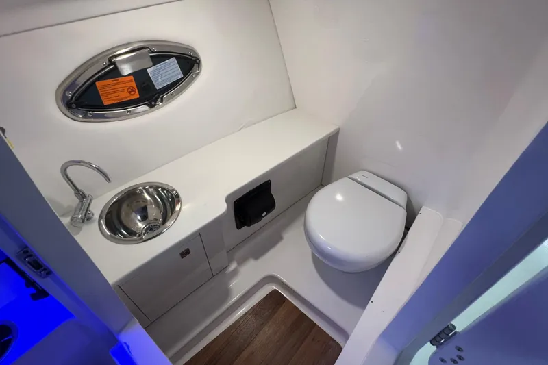 Slide: The Image of 2026 Robalo R257 Dual Console boat bathroom with sink and toilet. - 15