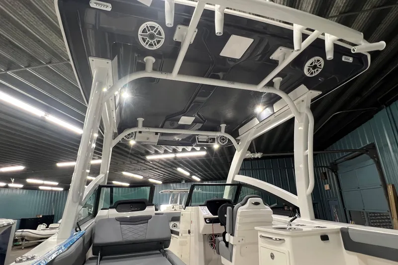 Slide: The Image of 2026 Robalo R257 Dual Console boat interior with modern seating and overhead speakers. - 16
