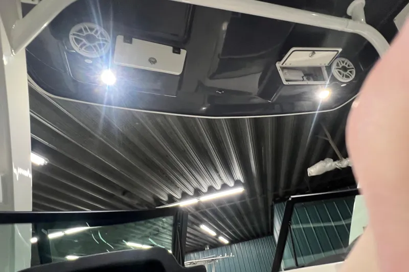 Slide: The Image of Interior view of 2026 Robalo R257 Dual Console boat ceiling with lights and speakers. - 17