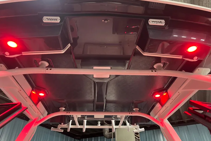 Slide: The Image of 2026 Robalo R257 Dual Console boat with red LED lights on the ceiling. - 18