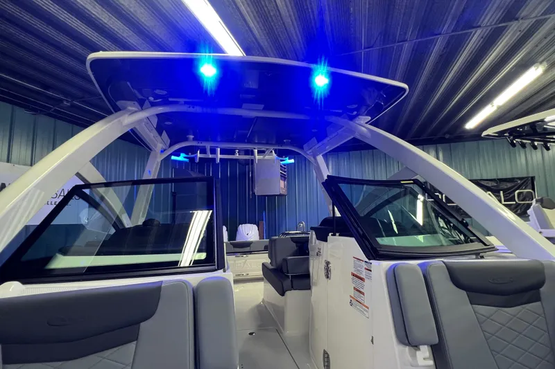 Slide: The Image of 2026 Robalo R257 Dual Console boat interior with blue LED lights and modern seating. - 24