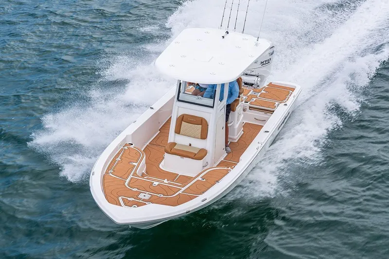 Slide: The Image of Manufacturer Provided Image: 2025 NauticStar 274 Bay boat cruising on water. - 2