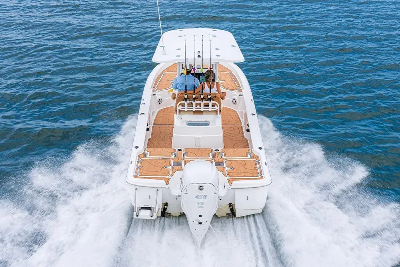 Slide: The Image of Manufacturer Provided Image: 2025 NauticStar 274 Bay boat cruising on open water. - 3