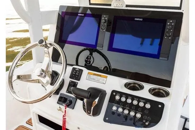 Slide: The Image of Manufacturer Provided Image: 2025 NauticStar 274 Bay boat dashboard with dual screens. - 7