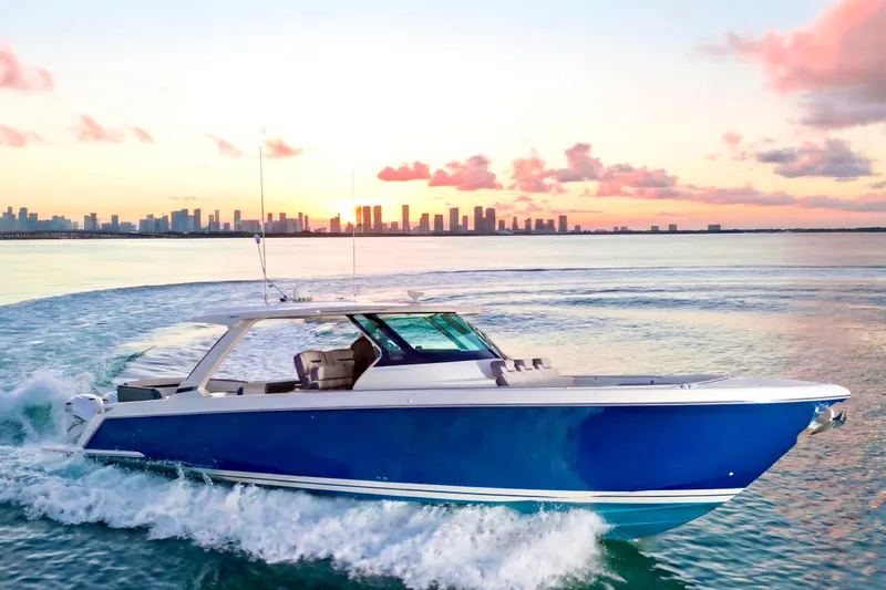 The Image of 2020 Tiara Yachts 43 LS cruising at sunset with city skyline in background. - 0