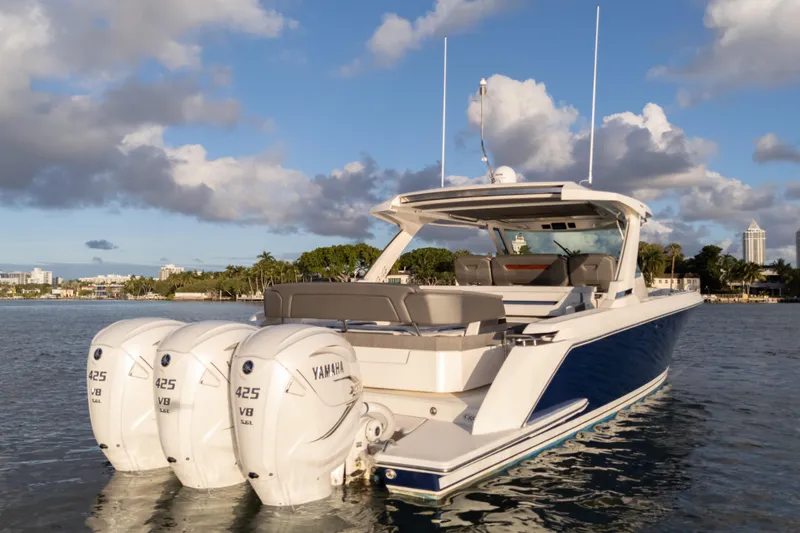 Slide: The Image of 2020 Tiara Yachts 43 LS with triple Yamaha 425 V8 engines on calm water. - 10