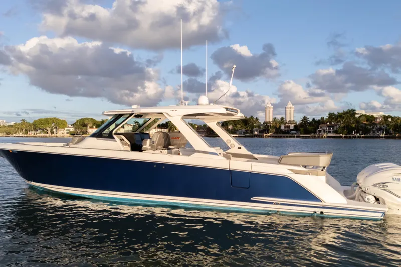 Slide: The Image of 2020 Tiara Yachts 43 LS boat on calm water with scenic background. - 13