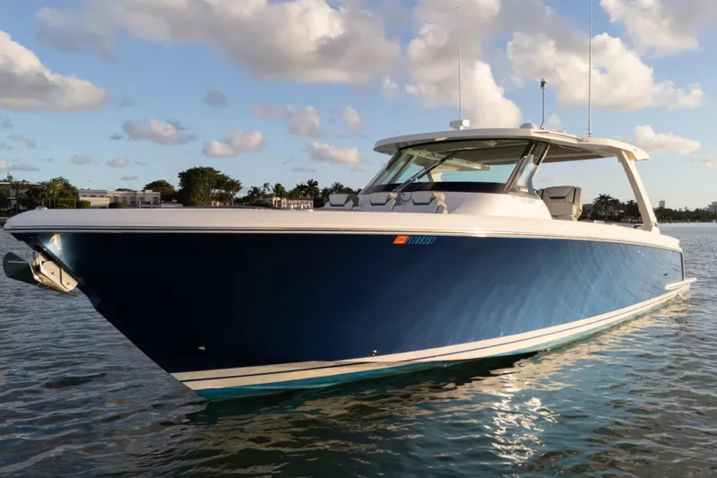 Slide: The Image of 2020 Tiara Yachts 43 LS in water, blue hull, sunny day, scenic background. - 14